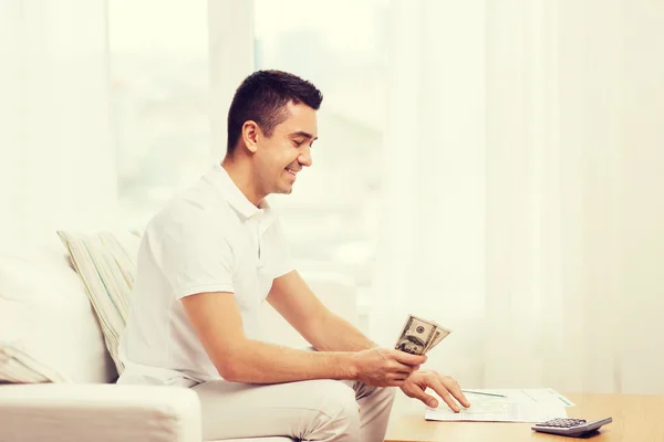 Man with papers and calculator at home — Stock Photo, Image
