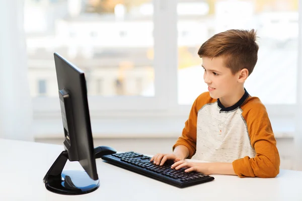 Smiling boy with computer at home — Stock Photo, Image