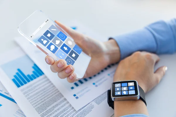 Close up of hands with smart phone and watch icons — Stock Photo, Image