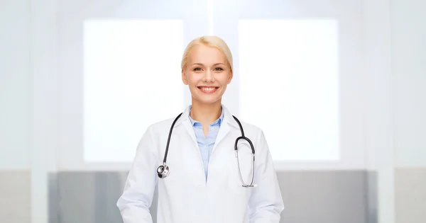 Sorridente medico donna in cappotto bianco — Foto Stock