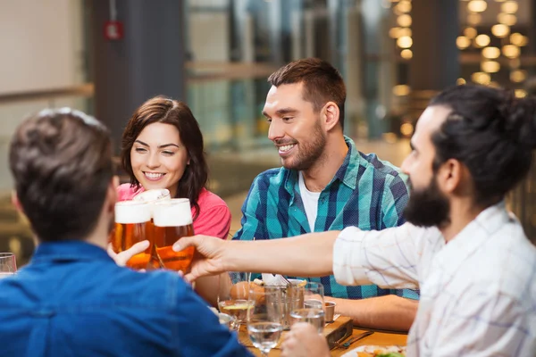 Přátelé stolování a pití piva v restauraci — Stock fotografie