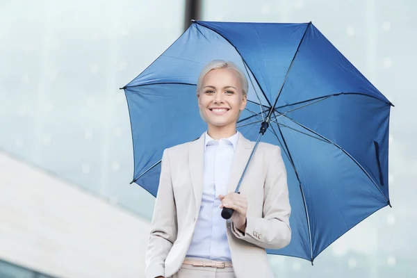 Young smiling businesswoman with umbrella outdoors — Stock Photo, Image