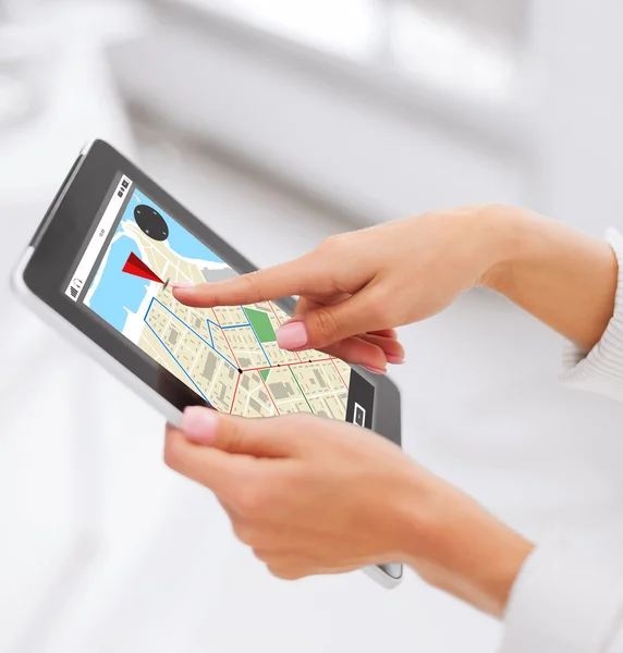 Close up of hands with navigator map on tablet pc — Stockfoto