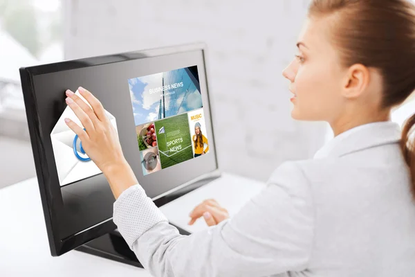 Woman with web pages on touchscreen in office — Stockfoto