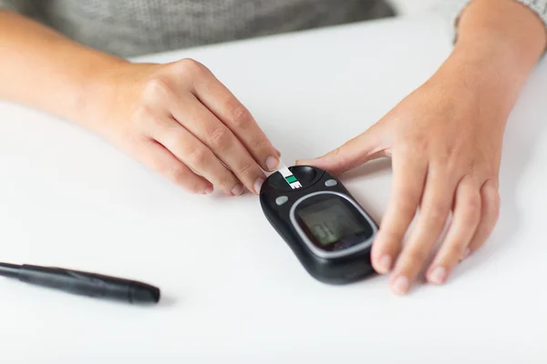 Close up of woman making blood test by glucometer — Stock Photo, Image