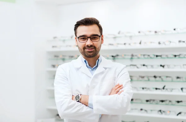 Man optician in glasses and coat at optics store — Stock Photo, Image