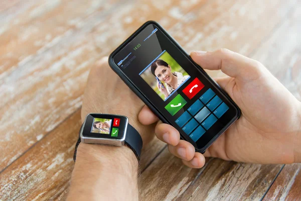 Close up of hands with smart phone and watch — Stock Photo, Image