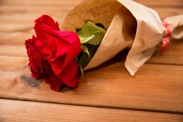 Close up of red roses bunch wrapped into paper — Stock Photo, Image