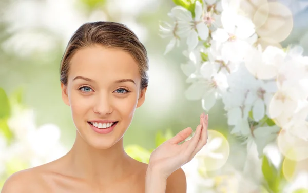 Smiling young woman face and shoulders Stock Image