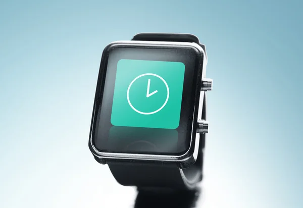 Close up of black smart watch with clock icon — Stock Photo, Image