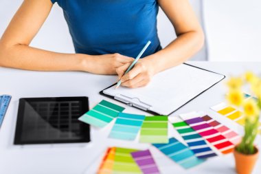 woman working with color samples for selection clipart