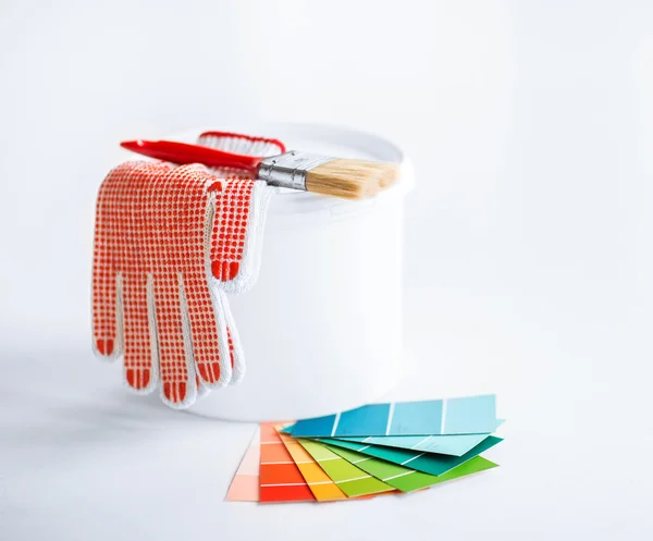 Paintbrush, paint pot, gloves and pantone samplers — Stock Photo, Image