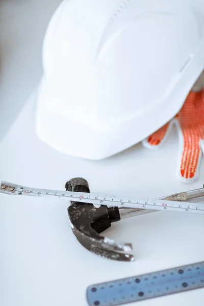 Blueprint, flexible ruller, helmet and hammer — Stock Photo, Image