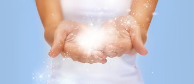 magic twinkles or fairy dust on female hands clipart