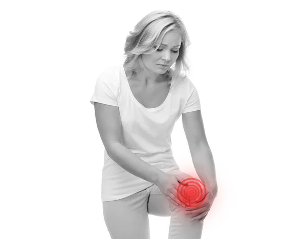 Unhappy woman suffering from pain in leg — Stock Photo, Image
