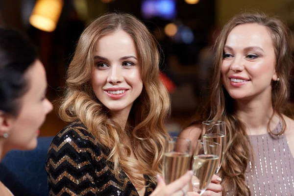 Happy women with champagne glasses at night club — Stock Photo, Image