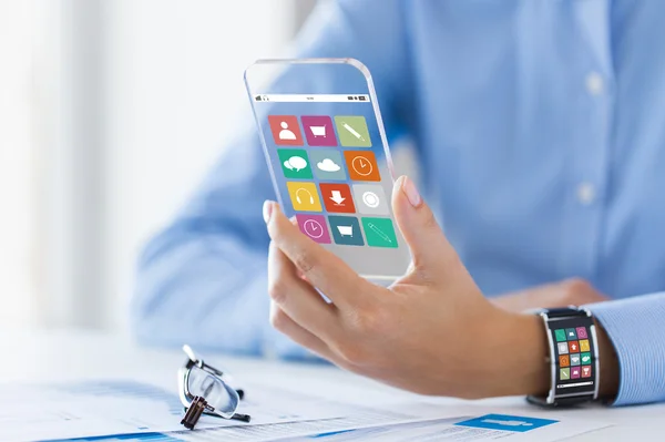 Hand with app icons on smart phone and watch — Stockfoto