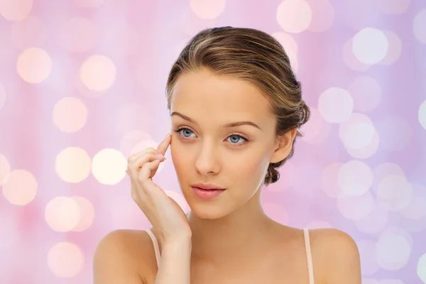 Young woman applying cream to her face — Stock Photo, Image