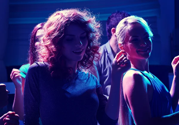 Group of happy friends dancing in night club Stock Image