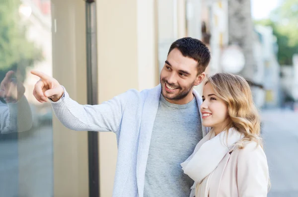 Glade par som handler og ser på butikkvindu – stockfoto