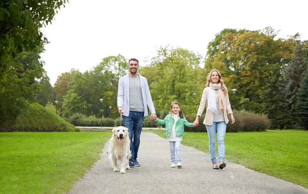 Happy family with labrador retriever dog in park — Stock Photo, Image