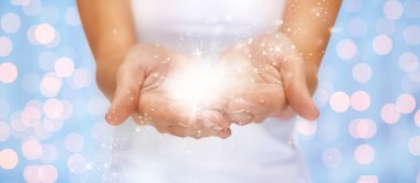 magic twinkles or fairy dust on female hands clipart