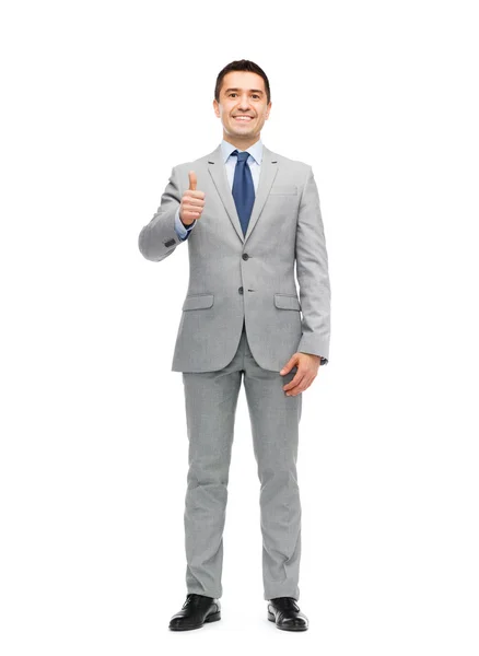 Homem de negócios feliz em terno mostrando polegares para cima — Fotografia de Stock