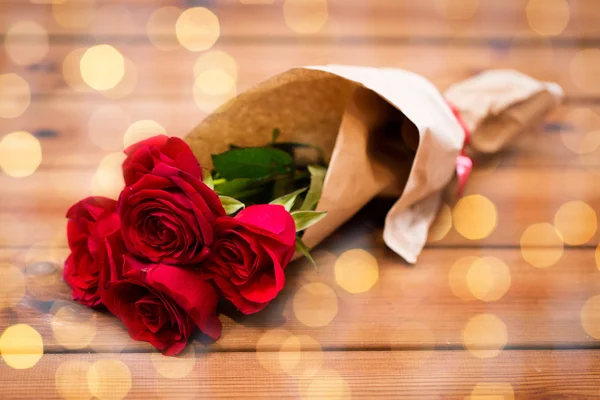 Close up of red roses bunch wrapped into paper — Stock Photo, Image