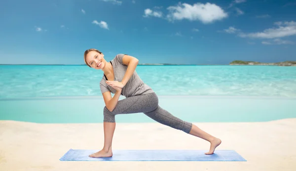 Mujer haciendo yoga bajo ángulo embestida pose en la estera —  Fotos de Stock