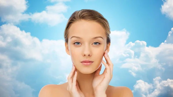 Young woman touching her face — Stock Photo, Image