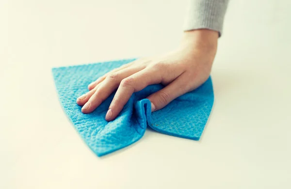 Close up of hand cleaning table surface with cloth — Stock Photo, Image