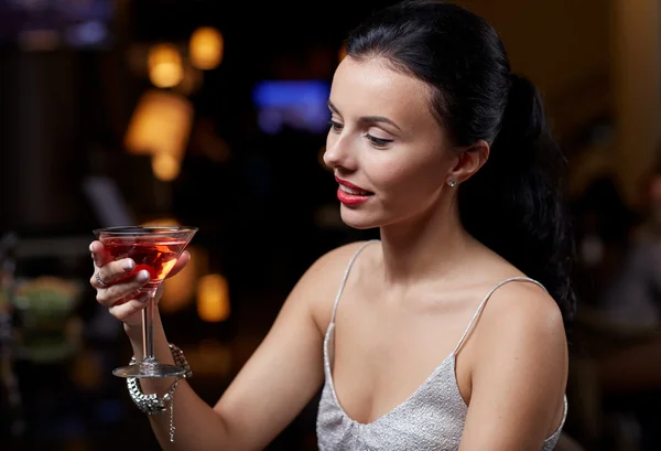 Glamorous woman with cocktail at night club or bar Stock Image