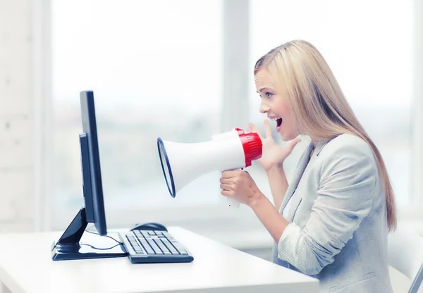 Strict businesswoman shouting in megaphone — Stock Photo, Image