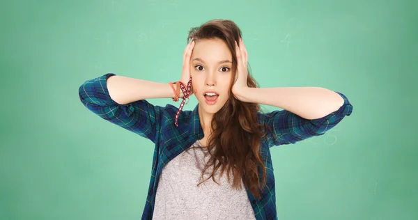 Happy pretty teenage student girl holding to head — Stock Photo, Image