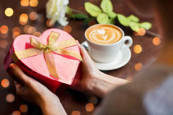 Close up of hands holding heart shaped gift box — Stock Photo, Image