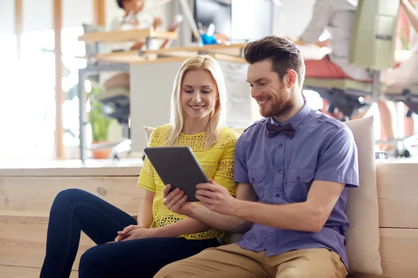 Happy creative team with tablet pc in office — Stock Photo, Image