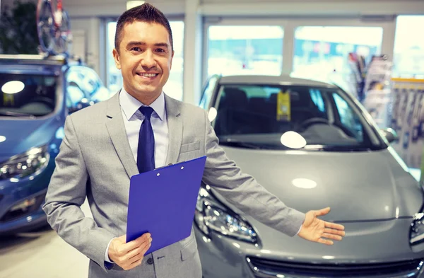 Happy man at auto show or car salon — Stock Photo, Image