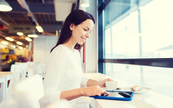 Lächelnde Frau mit Tablet-PC und Kaffee im Café — Stockfoto