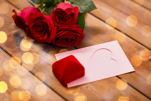 Nahaufnahme von Geschenkbox, roten Rosen und Grußkarte — Stockfoto