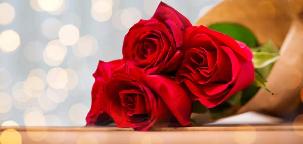 Close up of red roses bunch wrapped into paper — Stock Photo, Image