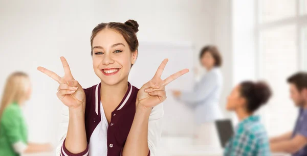 Teenage student girl showing peace at school — Stock Photo, Image