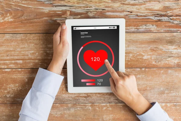 Close up of hands with heartbeat on tablet pc — Stock Photo, Image