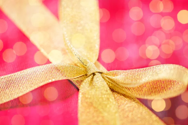 Close up of golden bow on red gift box Stock Image