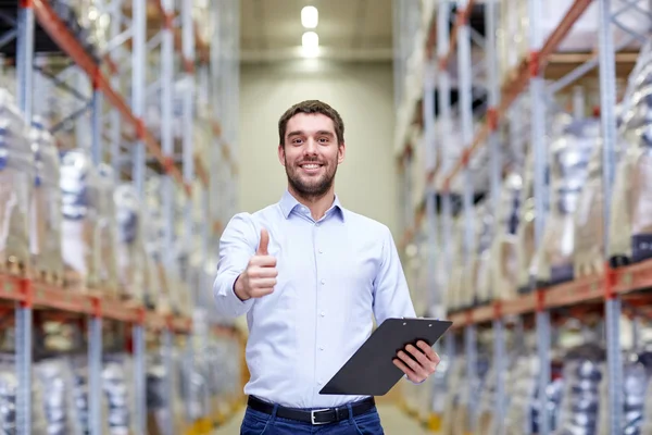 Happy man at warehouse showing thumbs up gesture — Stock Photo, Image