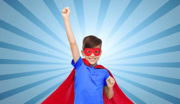 Boy in red super hero cape and mask showing fists — Stock Photo, Image