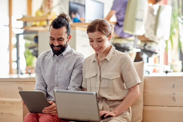 Creative team with tablet pc and laptop in office — Stock Photo, Image