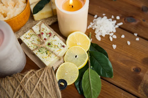 Close up of natural soap and candles on wood — Stock Photo, Image