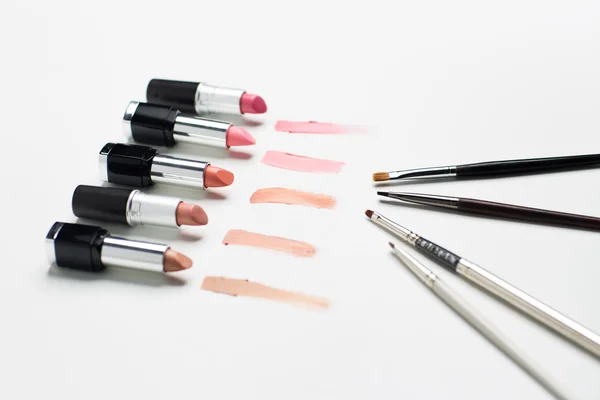 Close up of lipsticks range with makeup brushes — Stock Photo, Image