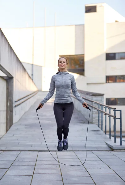 Happy woman exercising with jump-rope outdoors — Stock Photo, Image