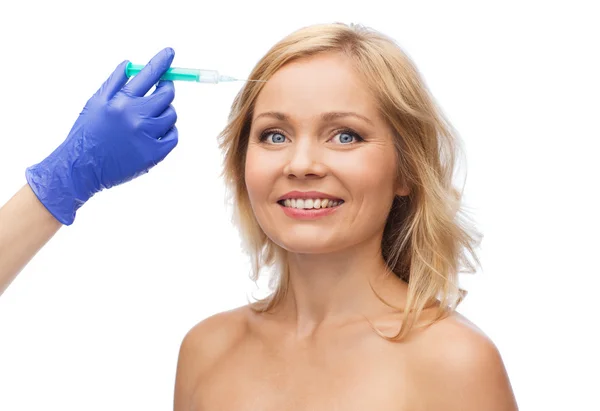 Happy woman face and beautician hand with syringe — Stok fotoğraf